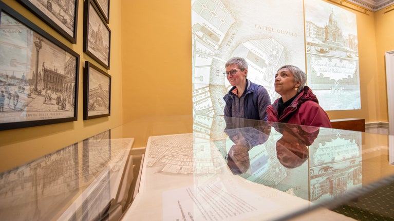 Visitors looking at the Ughi map at the Beyond the View exhibition in the Mansion, Tatton Park